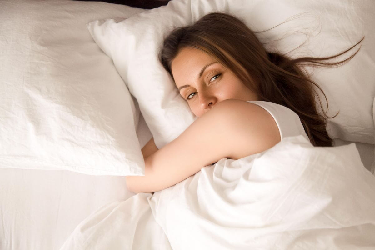 How to Create a Calm Bedroom for Growing Kids (Better Sleep & Less Stress) 2 amy lying in bed