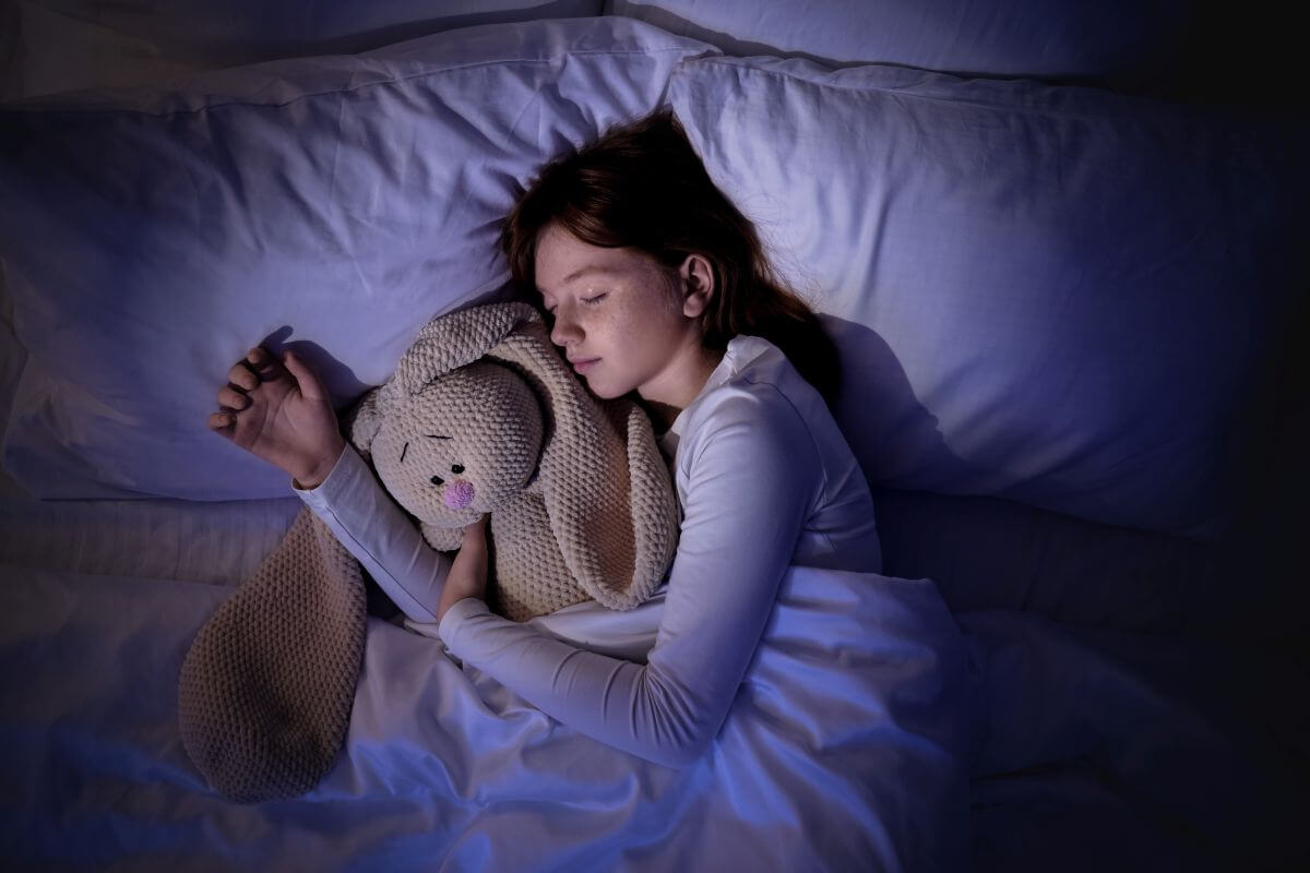 How to Create a Calm Bedroom for Growing Kids (Better Sleep & Less Stress) 1 girl sleeping soudly
