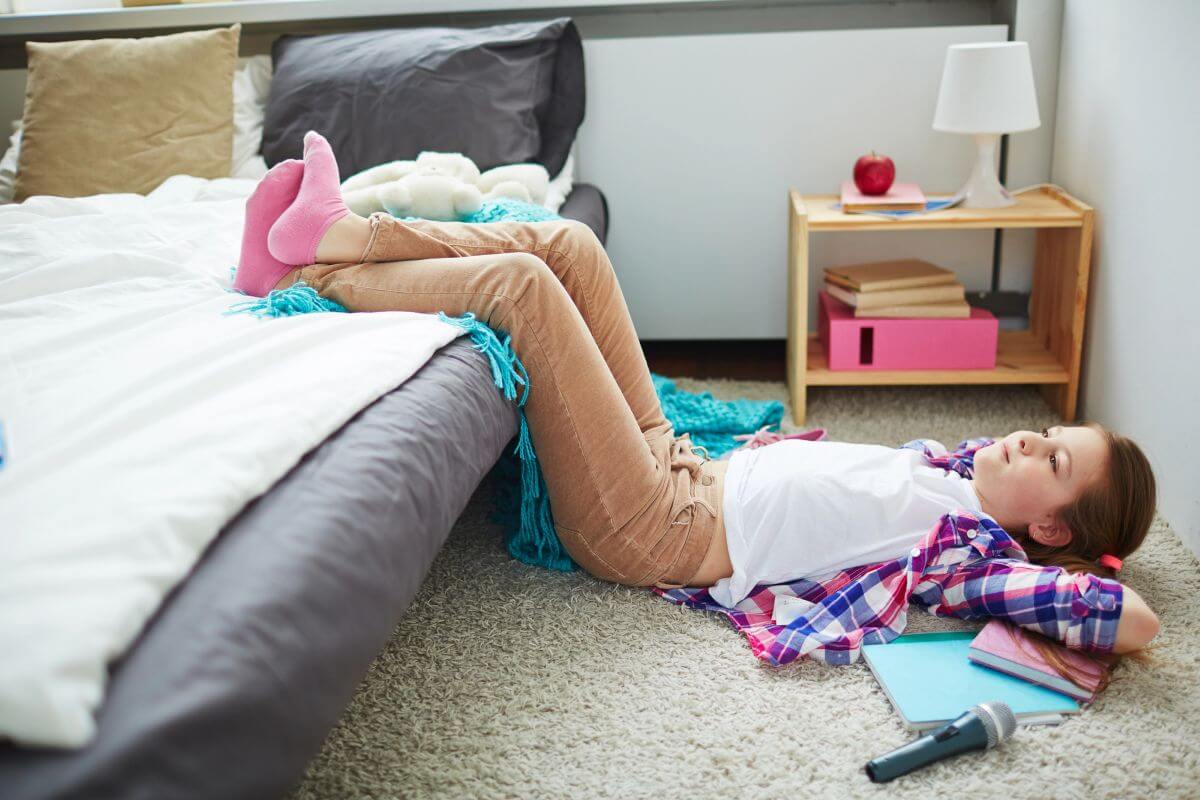 Small Double Beds for Kids and Teens: The Smart UK Bedroom Upgrade 2 preteen lying on floor of bedroom with feet on small double bed