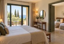 Before you book a family room: the layout questions that matter Hotel double bedroom with an open connecting doorway to a room with two single beds.